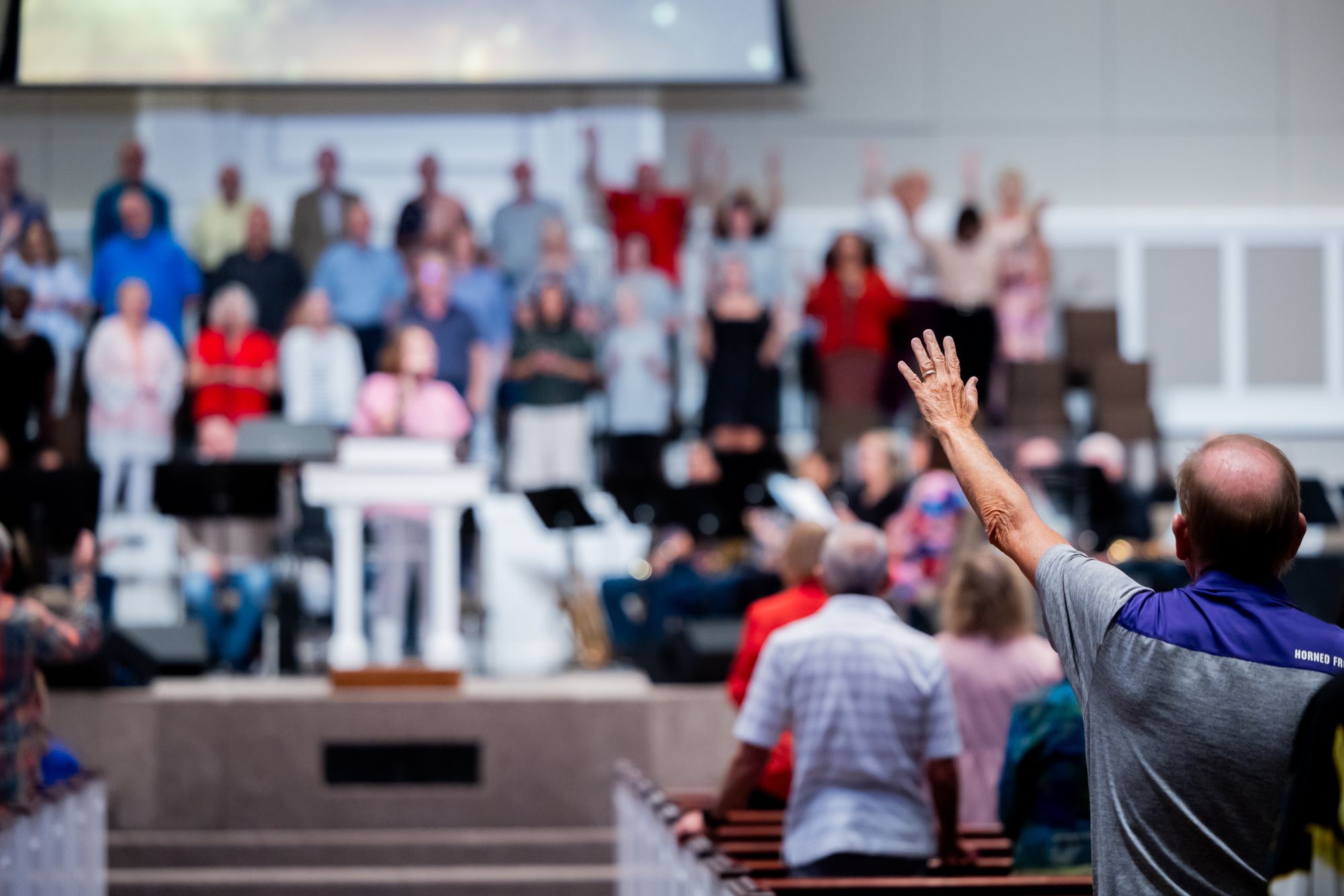 A worshipper with a raised hand during a church service